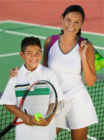 simsearch:693-06013834,k - Mother and son by net on tennis court, portrait, high angle view Stock Photo - Premium Royalty-Free, Code: 693-03299487
