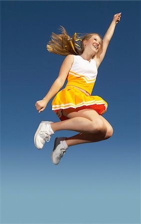 simsearch:693-03299836,k - Cheerleader jumping, mid-air, low angle view, (low angle view) Stock Photo - Premium Royalty-Free, Code: 693-03299611