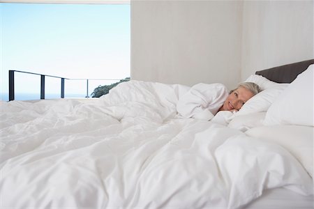 simsearch:693-03707745,k - Mature woman lying in bed, smiling Stock Photo - Premium Royalty-Free, Code: 693-03304380