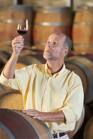 food specialist - Man wine-tasting aside wine casks Stock Photo - Premium Royalty-Free, Code: 693-03304569