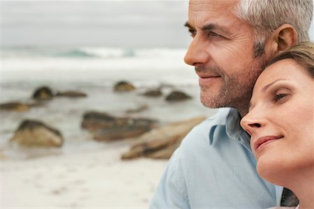 Close up of couple on beach, woman resting her head on man's shoulder Stock Photo - Premium Royalty-Free, Code: 693-03304709