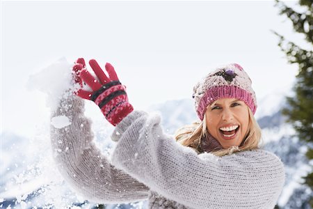 snowball fight - Woman catching snowball Stock Photo - Premium Royalty-Free, Code: 693-03305313