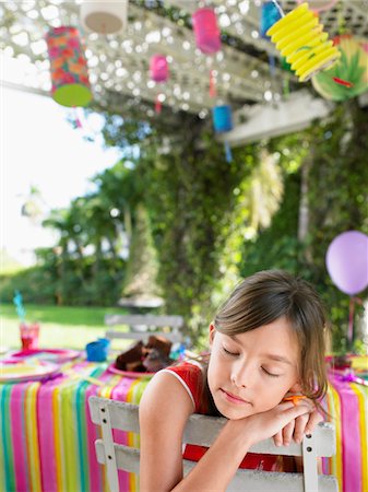 simsearch:693-03305634,k - Young girl (7-9) sleeping on patio after birthday party, close-up Stock Photo - Premium Royalty-Free, Code: 693-03305587