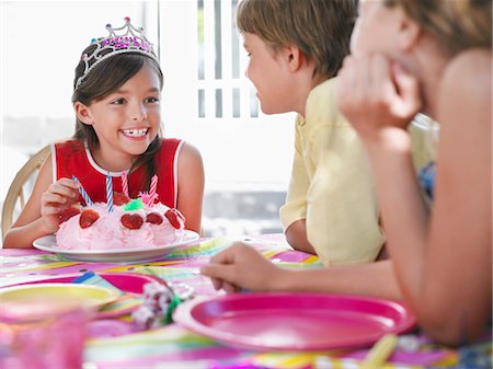 simsearch:693-03305634,k - Girl (7-9) with birthday cake talking to guests at birthday party Stock Photo - Premium Royalty-Free, Code: 693-03305595