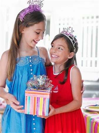 simsearch:693-03305634,k - Portrait of two girls (7-9, 10-12) in tiaras, holding present, smiling Stock Photo - Premium Royalty-Free, Code: 693-03305598