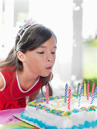 simsearch:693-03305634,k - Young girl (7-9) blowing out birthday candles, close-up Stock Photo - Premium Royalty-Free, Code: 693-03305591