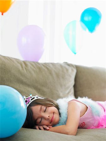 simsearch:693-03305634,k - Young girl (7-9) sleeping on sofa with balloons Stock Photo - Premium Royalty-Free, Code: 693-03305630