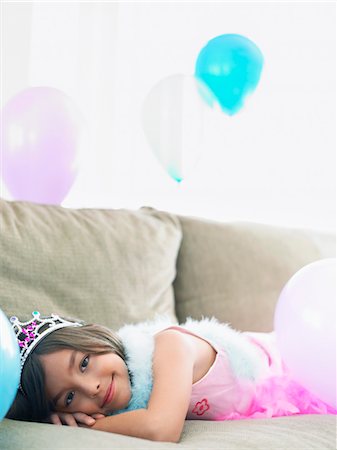simsearch:693-03305634,k - Young girl (7-9) lying on sofa with balloons Stock Photo - Premium Royalty-Free, Code: 693-03305631