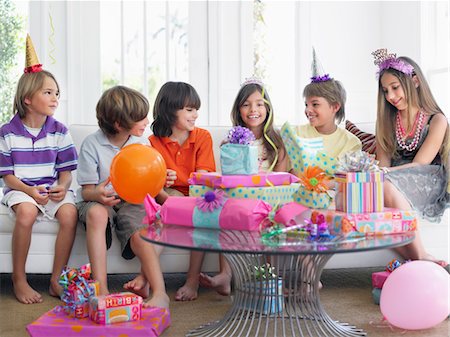 simsearch:693-03305634,k - Group of children (7-12) sitting on sofa at birthday party Stock Photo - Premium Royalty-Free, Code: 693-03305648