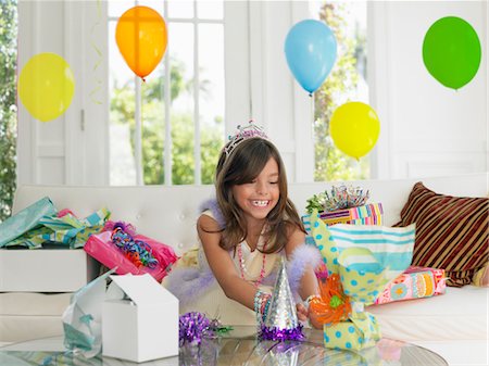 simsearch:693-03305634,k - Young girl (7-9) opening birthday presents, smiling Stock Photo - Premium Royalty-Free, Code: 693-03305662