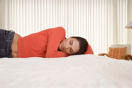 Mid-adult woman sleeping on bed Stock Photo - Premium Royalty-Free, Code: 693-03305750