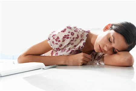 Woman Resting on Desk Stock Photo - Premium Royalty-Free, Code: 693-03305845