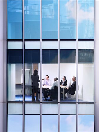 Group of business people at meeting in office, view from building exterior Stock Photo - Premium Royalty-Free, Code: 693-03305949