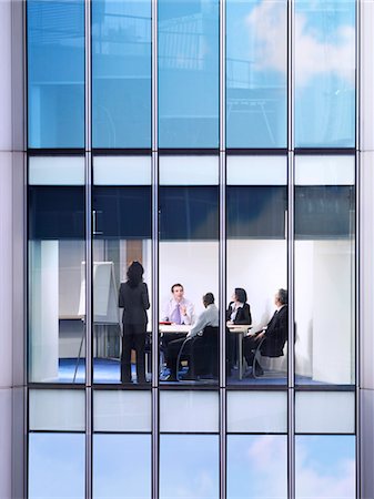 Group of business people at meeting in office, view from building exterior Stock Photo - Premium Royalty-Free, Code: 693-03305951