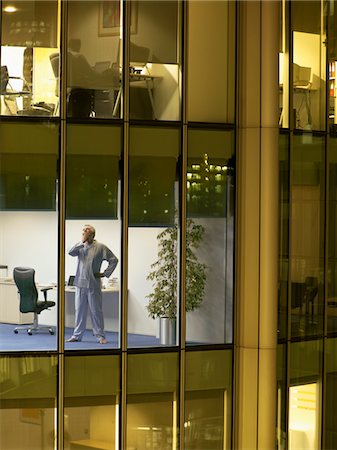 Male surgeon standing in office, view from building exterior Stock Photo - Premium Royalty-Free, Code: 693-03305974