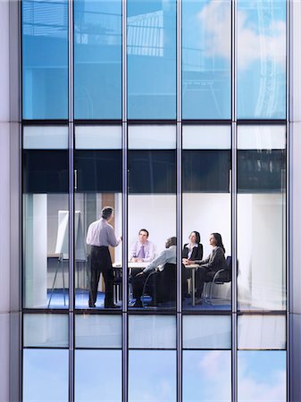 Group of business people at meeting in office, view from building exterior Stock Photo - Premium Royalty-Free, Code: 693-03305994