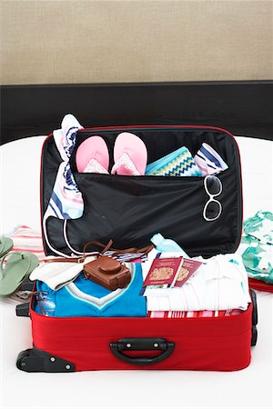 Open suitcase on bed, elevated view Stock Photo - Premium Royalty-Free, Code: 693-03307059