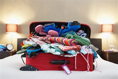 Open suitcase on bed Stock Photo - Premium Royalty-Free, Code: 693-03307064