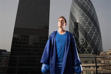 Boxer standing on downtown rooftop, London, England Stock Photo - Premium Royalty-Free, Code: 693-03307339