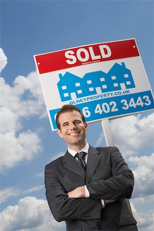 simsearch:693-03308239,k - Real estate agent in front of sold sign, against cloudy sky Stock Photo - Premium Royalty-Free, Code: 693-03308292