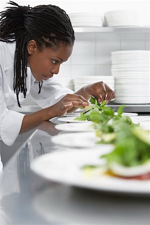 Female chef preparing salad in kitchen Stock Photo - Premium Royalty-Free, Code: 693-03308919