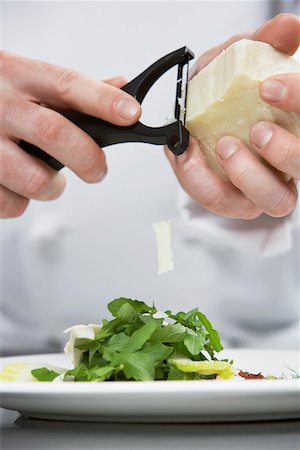 Male chef grating cheese over salad, mid section Stock Photo - Premium Royalty-Free, Code: 693-03308929