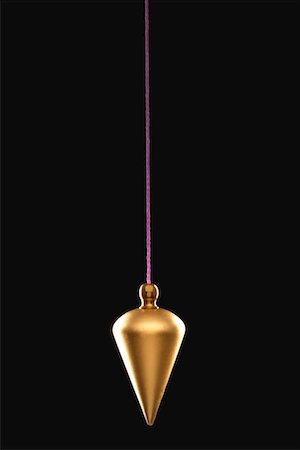 Pendulum on string, black background Stock Photo - Premium Royalty-Free, Code: 693-03309571