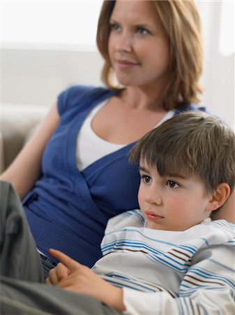 Mother and son (5-6) watching television on couch Stock Photo - Premium Royalty-Free, Code: 693-03300201