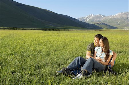 simsearch:614-05557077,k - Young couple sitting in mountain field looking at view, full length Stock Photo - Premium Royalty-Free, Code: 693-03301622