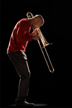 Man Playing Trombone, side view Stock Photo - Premium Royalty-Free, Code: 693-03302049