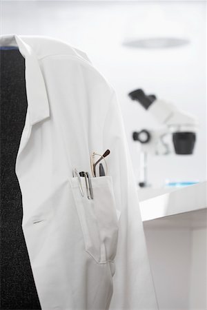 Scientists white coat in laboratory, with microscope in background Stock Photo - Premium Royalty-Free, Code: 693-03302274