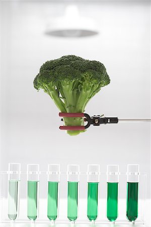 Broccoli over test tubes containing green chemicals Stock Photo - Premium Royalty-Free, Code: 693-03302275