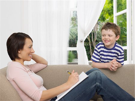 simsearch:693-03305634,k - Mother and young son by couch Stock Photo - Premium Royalty-Free, Code: 693-03302347