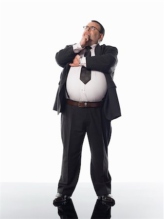 fat man full body - Overweight businessman standing with hand on chin Stock Photo - Premium Royalty-Free, Code: 693-03303269