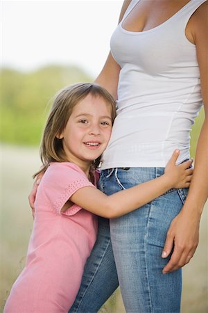 Little Girl Hugging Her Mother Stock Photo - Premium Royalty-Free, Code: 693-03314008