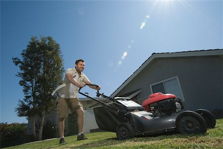 pushing - Man moving lawn, low angle Stock Photo - Premium Royalty-Free, Code: 693-03314062