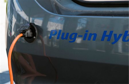 Close up of electrical plug recharging electric car Stock Photo - Premium Royalty-Free, Code: 693-03314212