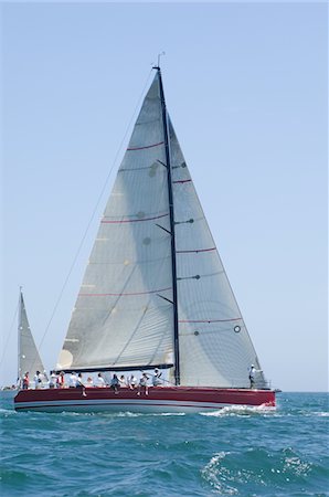 simsearch:693-03314237,k - Triangular sail on yacht in competitive team sailing event, California Stock Photo - Premium Royalty-Free, Code: 693-03314230