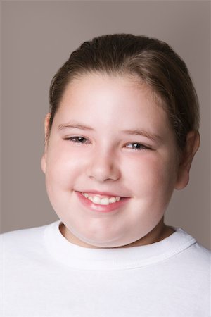 Overweight girl, smiling Stock Photo - Premium Royalty-Free, Code: 693-03314508