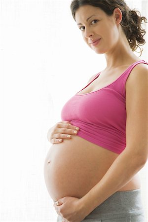 pregnant belly button - Studio portrait of pregnant woman Stock Photo - Premium Royalty-Free, Code: 693-03314547