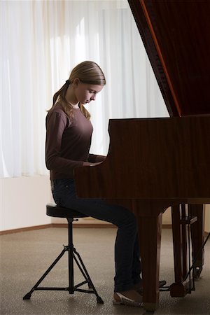 piano practice - Girl (13-15) playing piano Stock Photo - Premium Royalty-Free, Code: 693-03315276