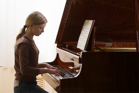 piano practice - Girl (13-15) playing piano Stock Photo - Premium Royalty-Free, Code: 693-03315280