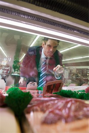 deli - Mature man looks through glass of meat counter in supermarket Stock Photo - Premium Royalty-Free, Code: 693-03315619