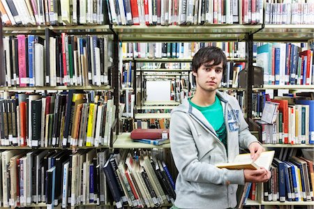 public - University student studying in library Stock Photo - Premium Royalty-Free, Code: 693-03317307