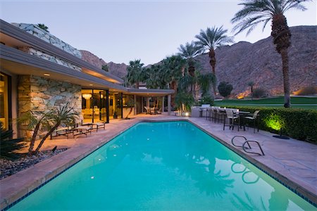 swimming pool night palm tree - Swimming pool exterior of Palm Springs home Stock Photo - Premium Royalty-Free, Code: 693-03317404