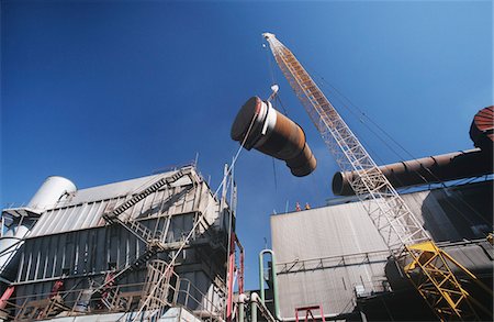 Installing fume extraction pipe into steel foundry smelter Stock Photo - Premium Royalty-Free, Code: 693-03310308