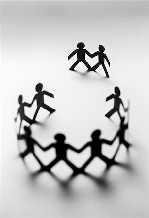 Paper dolls in circle with two bystanders Stock Photo - Premium Royalty-Free, Code: 693-03310914