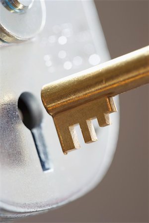 Golden key and padlock, close-up Stock Photo - Premium Royalty-Free, Code: 693-03311147