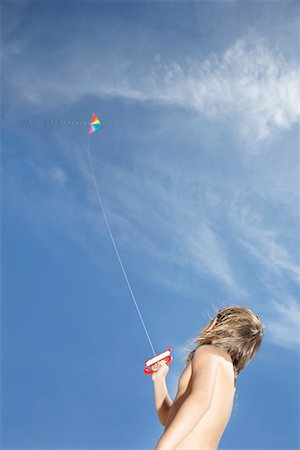 Boy (7-9) flying kite, low angle view Stock Photo - Premium Royalty-Free, Code: 693-03311853