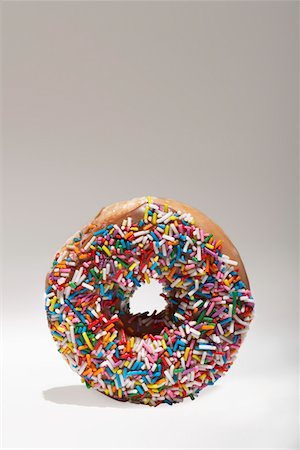 sprinkles - Rainbow sprinkles on doughnut Stock Photo - Premium Royalty-Free, Code: 693-03312118
